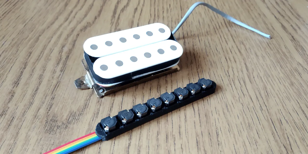 The Octaphonic Pickup 3D Printed with components solded near a real Humbucker Pickup for size comparison